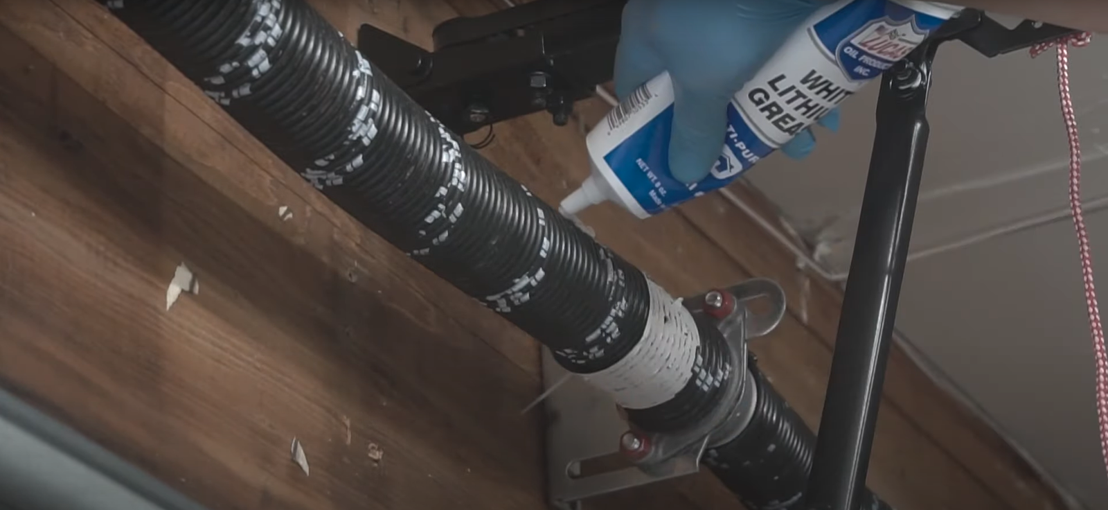 Technician performing garage door spring repair in Arcadia, Florida.