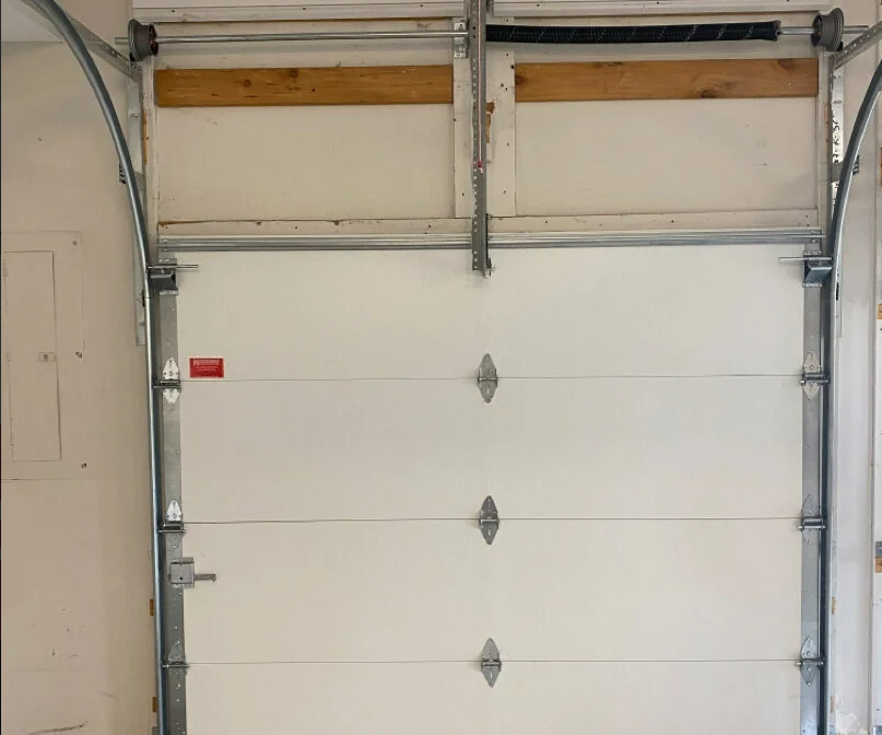 Technician performing garage door section replacement in Arcadia, Florida