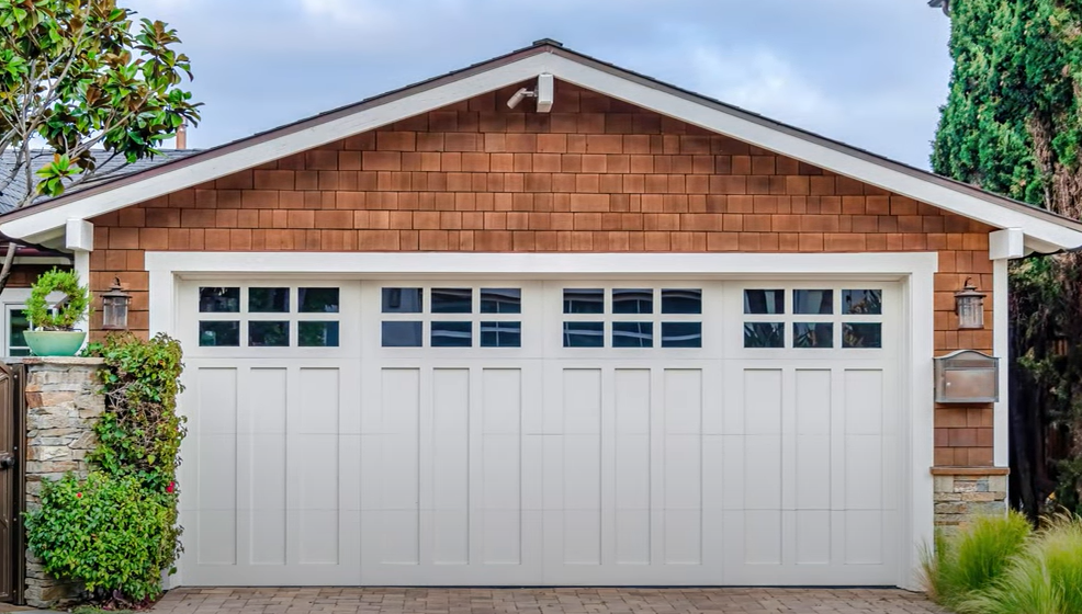 Technician providing same-day garage door repair services in Arcadia, Florida, fixing a residential garage door with professional tools