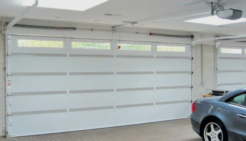 Technician providing local garage door repair services in Arcadia, Florida for a residential garage.