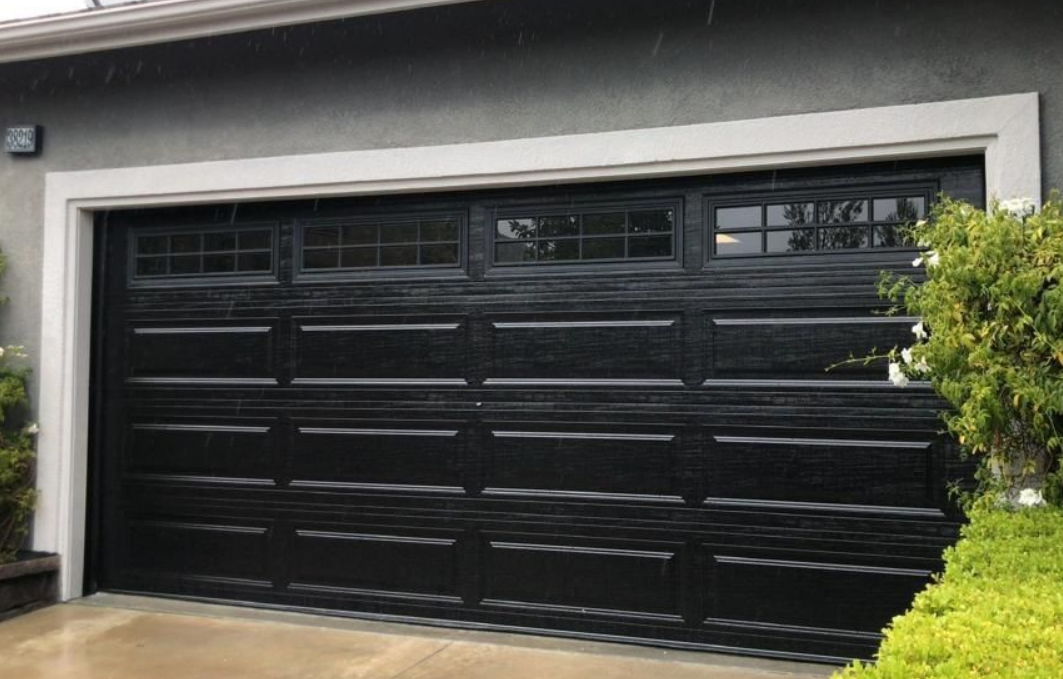 Technician providing local garage door repair services in Arcadia, Florida, fixing a residential garage door.