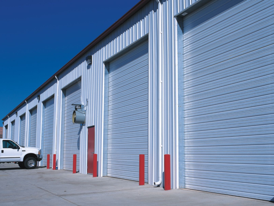 Technicians performing commercial garage door repair in Arcadia, Florida.