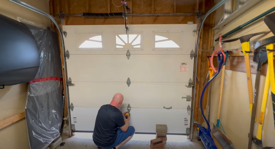 Technician performing garage door panel repair in Arcadia, Florida, ensuring smooth and safe operation of the door.
