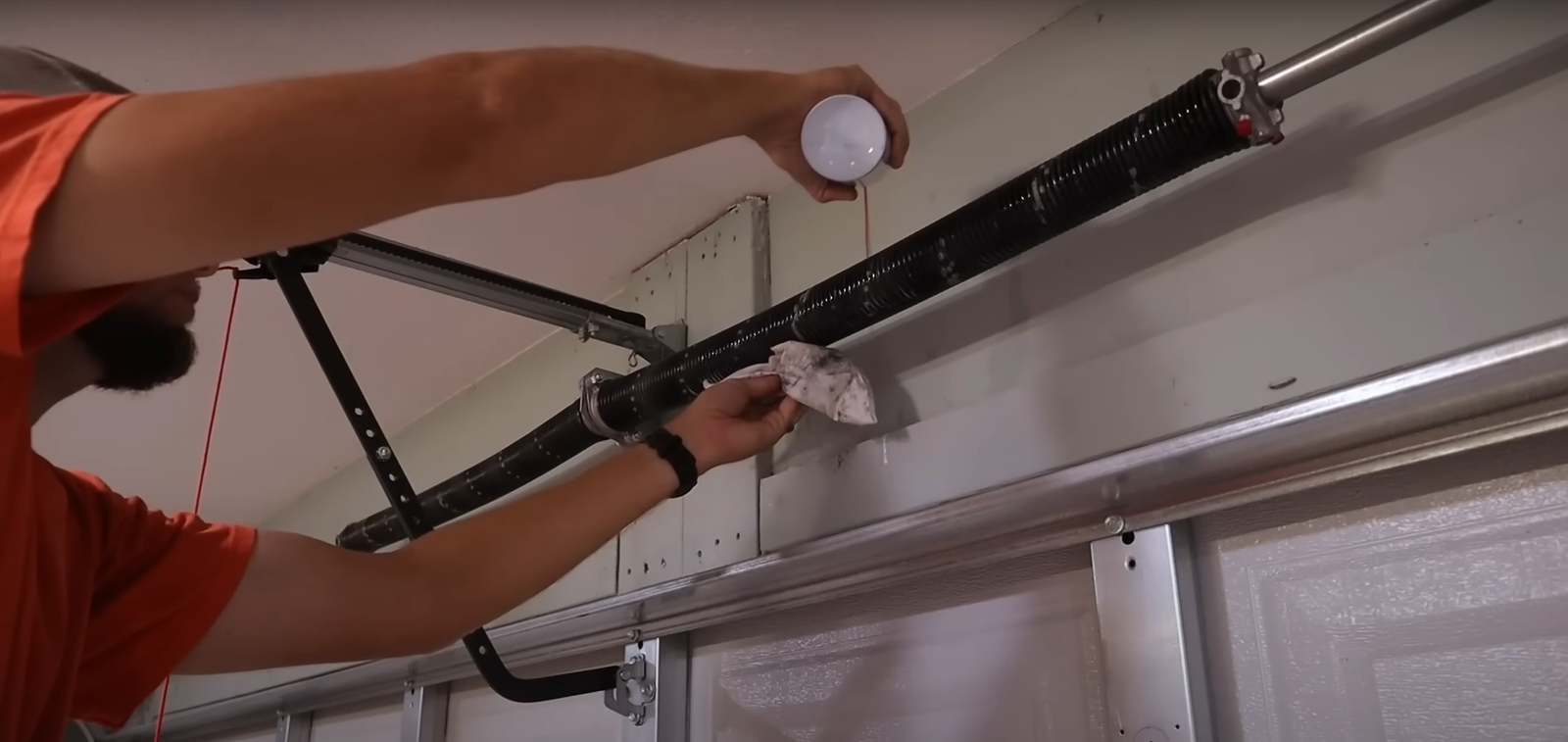 Technician performing garage door spring repair in Arcadia, Florida.