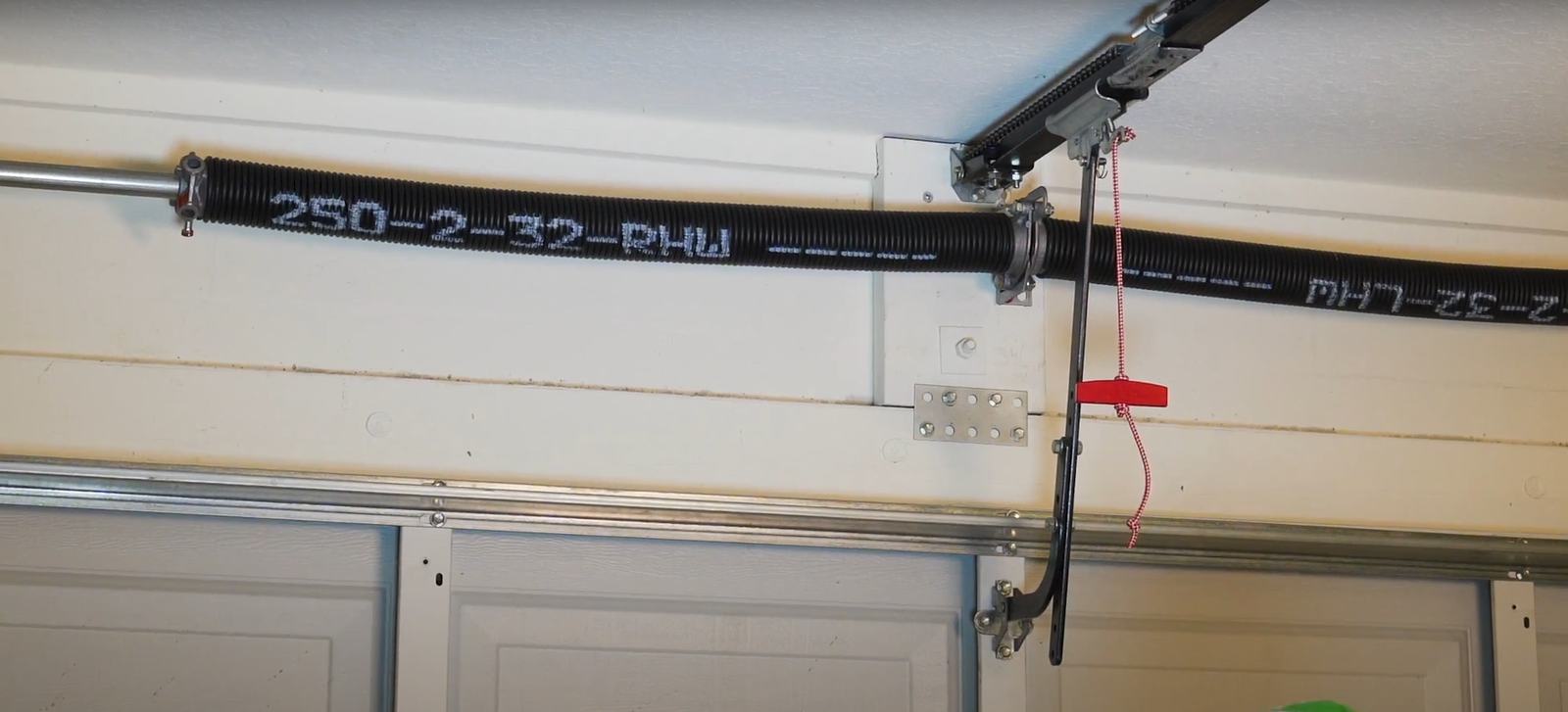 Technician performing garage door spring repair in Arcadia, Florida.